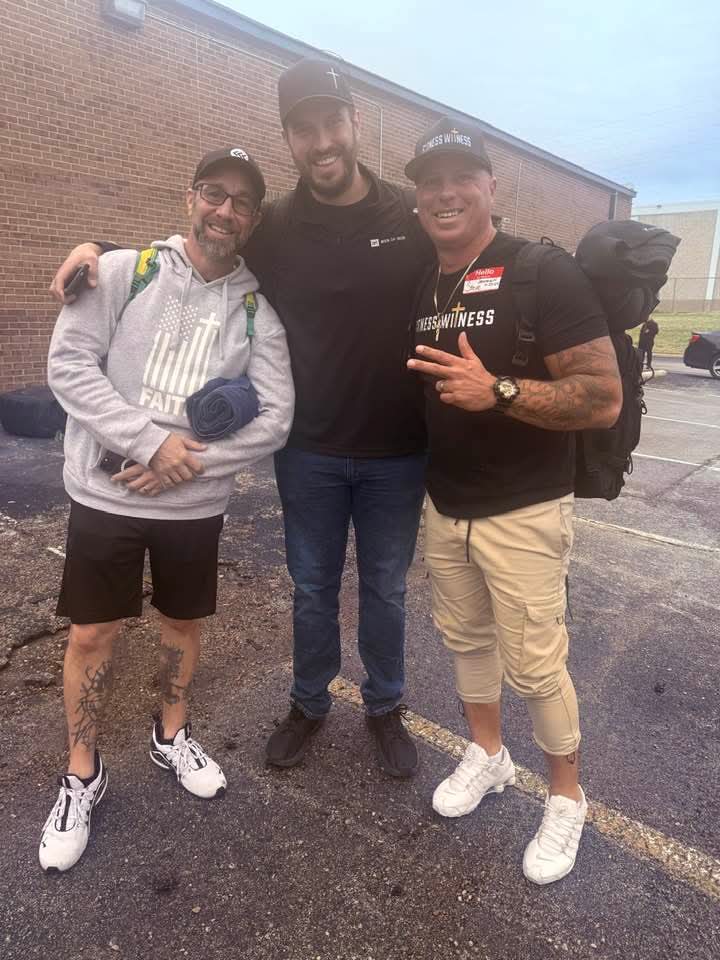 Greg with two men carrying backpacks before a street outreach to people living unsheltered.